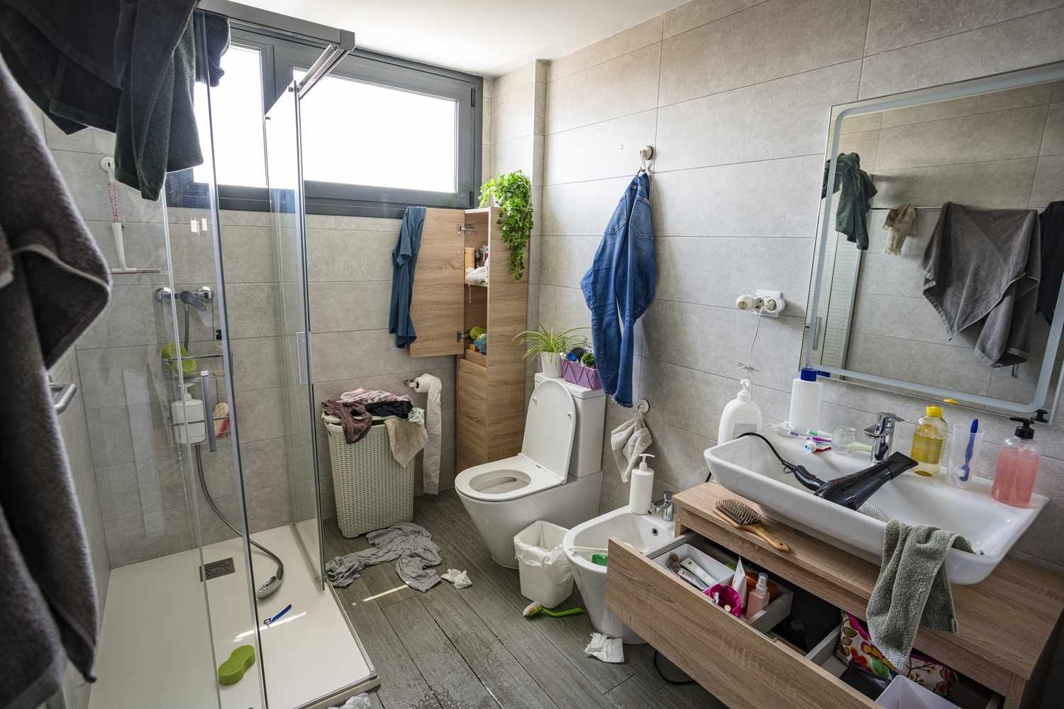 Cluttered untidy bathroom before washroom service
