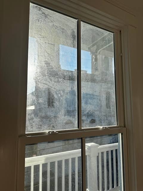 Streaky grimy window before cleaning